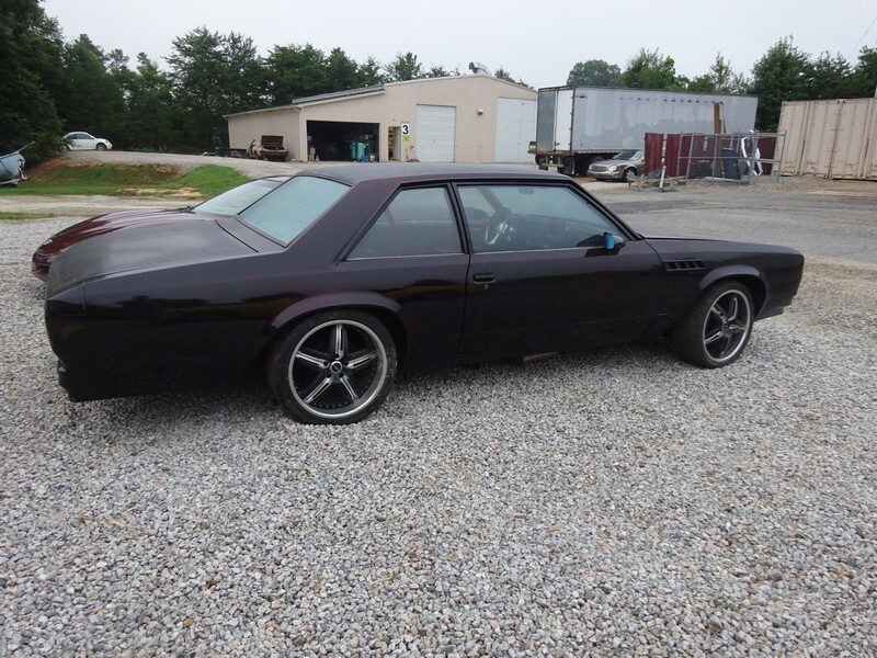 Custom dark maroon classic car.