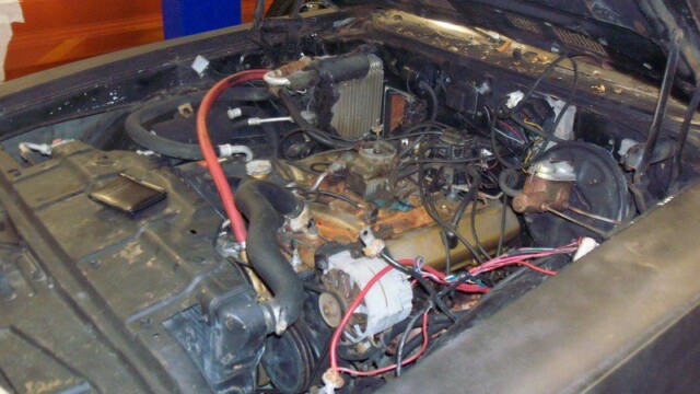 Oldsmobile engine bay, needs repair.
