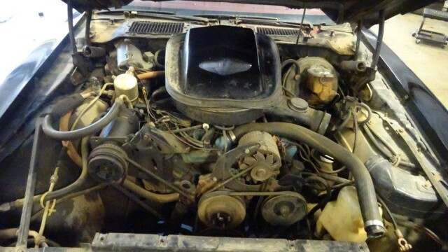 Dirty car engine under the hood.