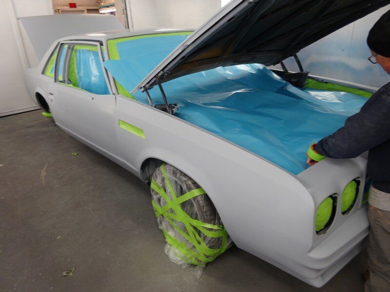 Gray classic car, underbody masked for paint.