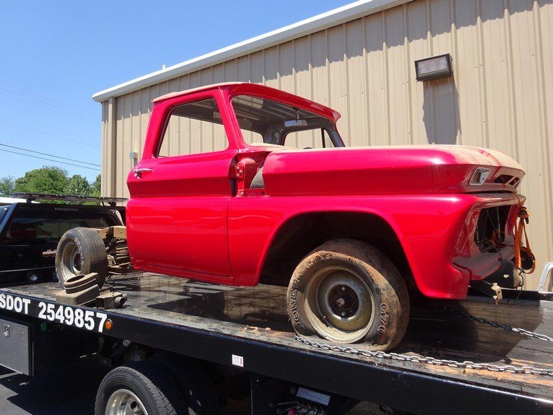 Red classic truck on tow truck.