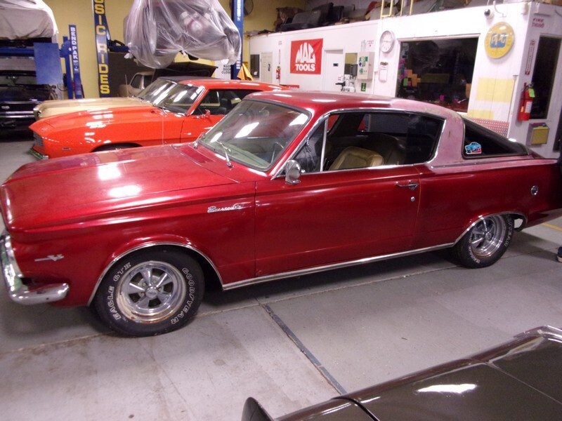 Red classic car in auto shop.