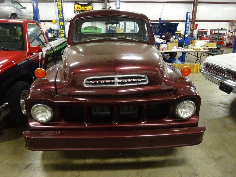 Maroon Studebaker truck front view.