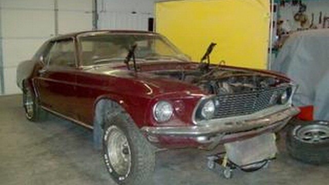 Red Ford Mustang in auto shop.