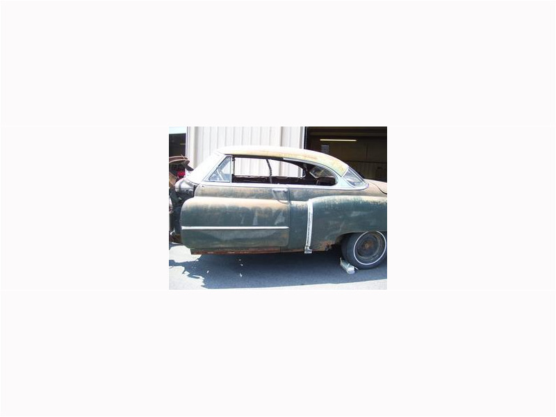 Here's an alt tag for the image: `Rusty vintage Cadillac coupe restoration project`