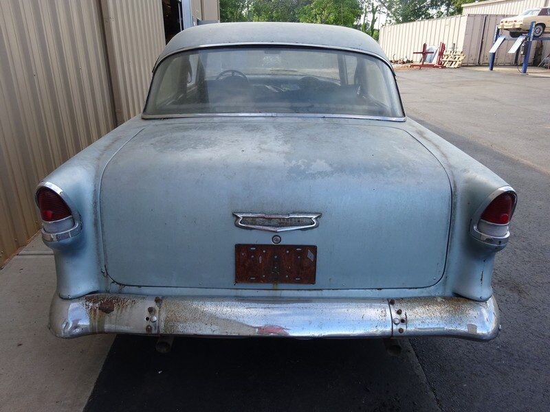 Rear view of a rusty vintage Chevy.