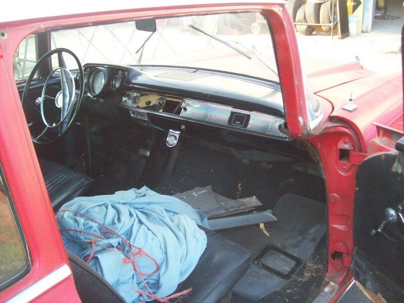 Red classic car interior, needs restoration.