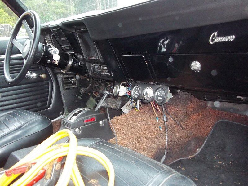 Black Camaro interior with jumper cables.