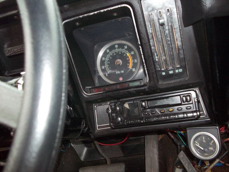 Classic car dashboard with gauges and radio.