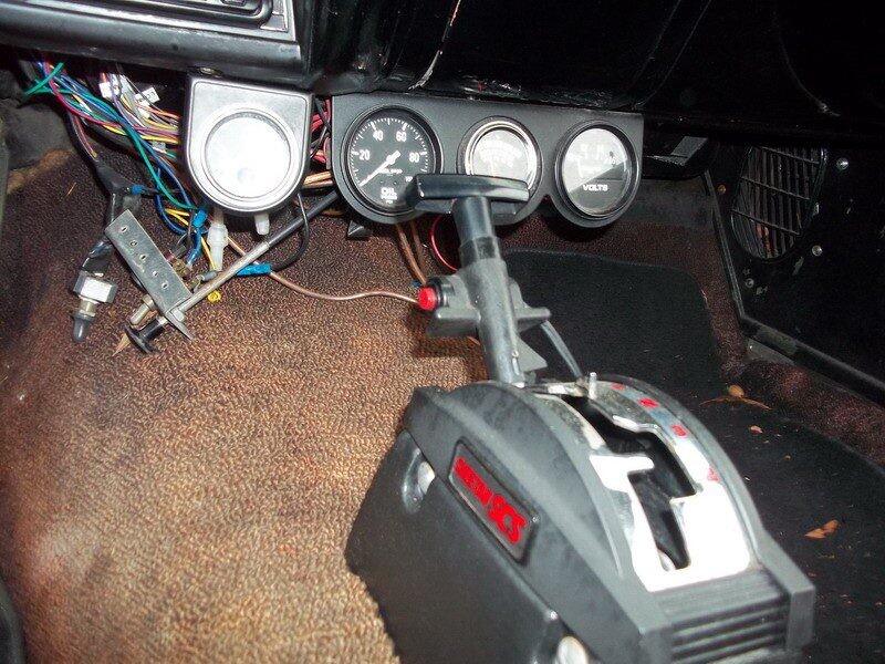 Classic car's custom gauges and shifter.