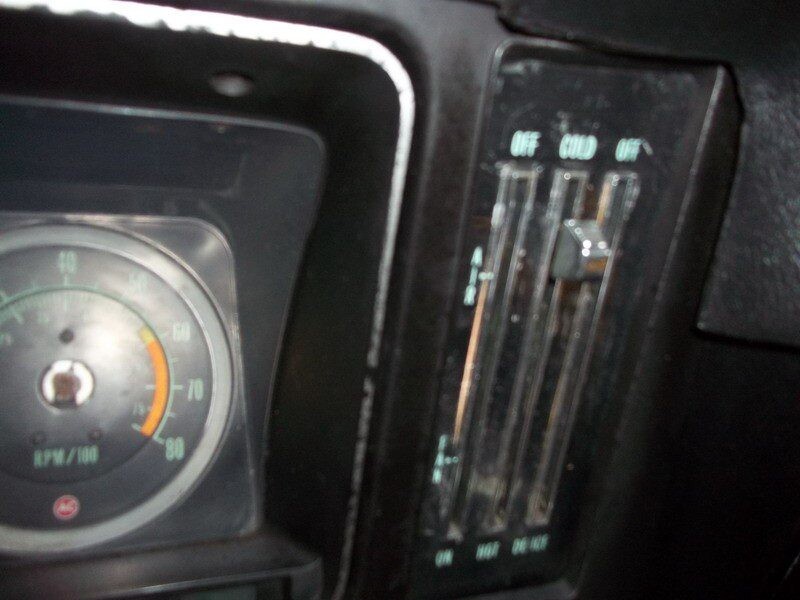 Classic car RPM gauge and climate controls.