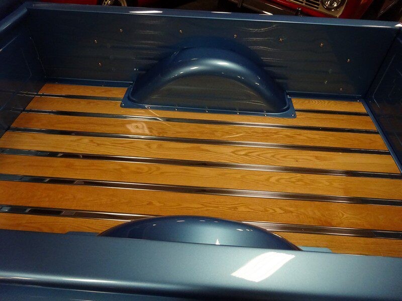 Wooden truck bed with metal strips.