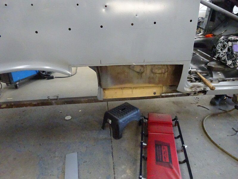 Car body repair: rusted floor panel.