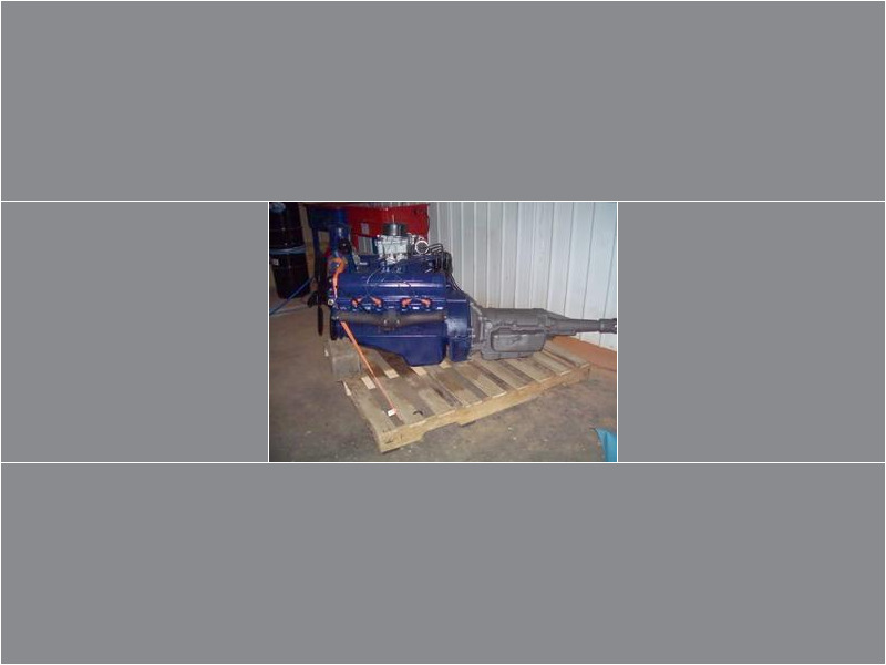 Here's an alt tag for the image: Blue Ford engine and transmission on pallet.