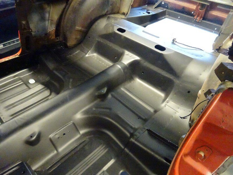 Here's an alt tag for the image: Car floor pan restoration in progress.