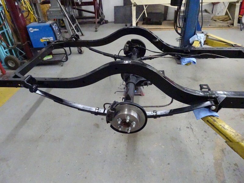 Black car chassis with rear axle.