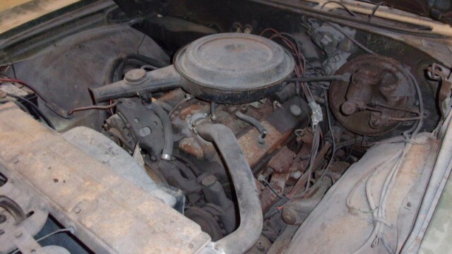 Rusty classic car engine bay.