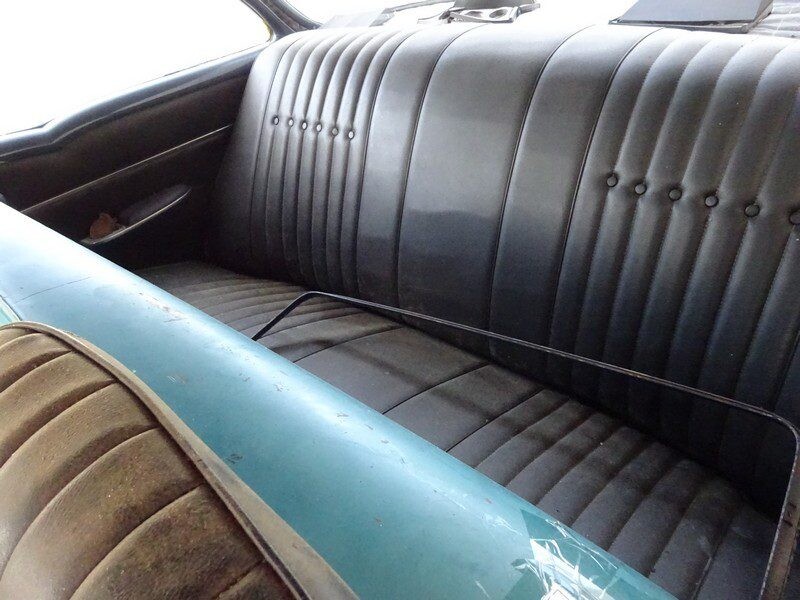 Classic car's backseat, black vinyl.