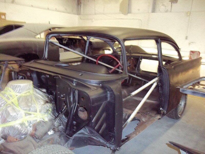 Black classic car body in progress.