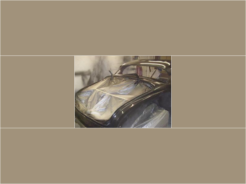 Here's an alt tag for the image: Black classic car, bodywork in progress.