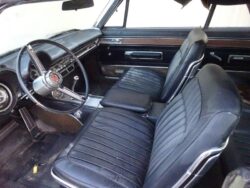 Classic car's interior: steering wheel, seats.