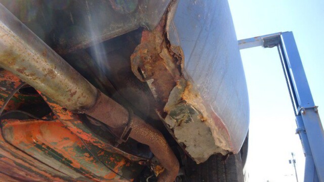Rusty car undercarriage needs repair.