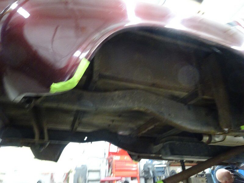 Car's undercarriage needing repair.