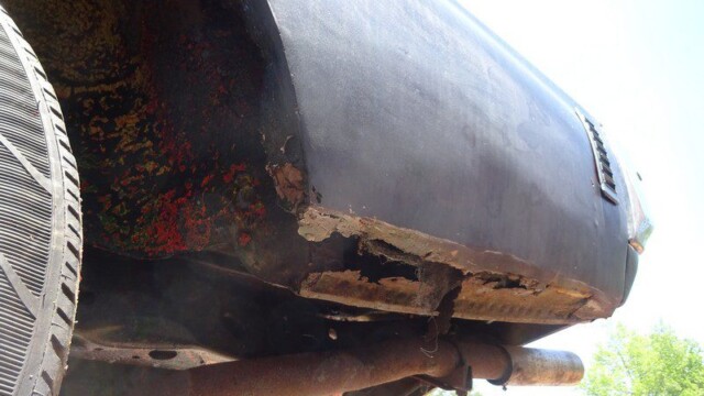 Rusty car fender needs repair.