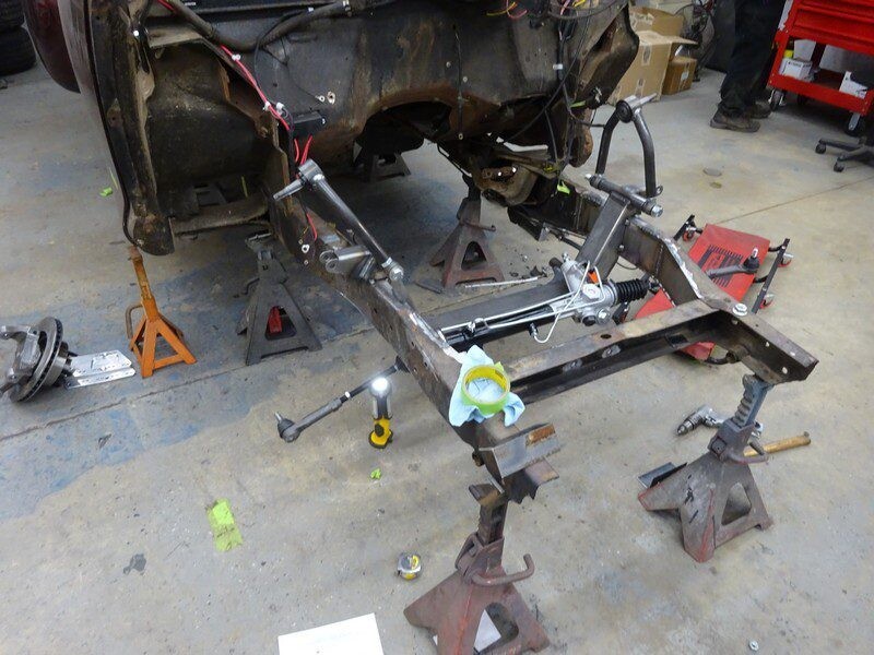 Classic car chassis under repair.