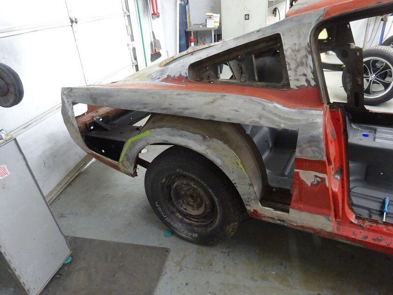 Red classic car bodywork in progress.