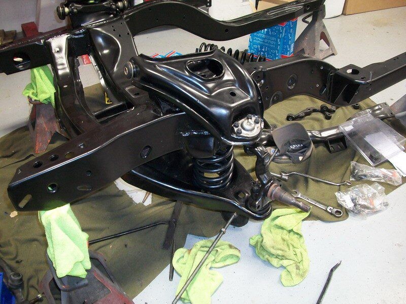 Black truck frame with suspension parts.