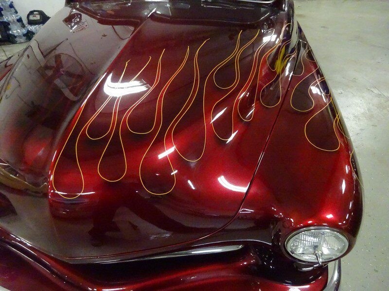 Red classic car with flame paint job.