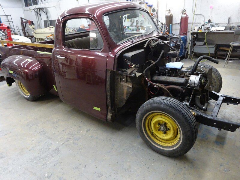 Maroon vintage truck under restoration.