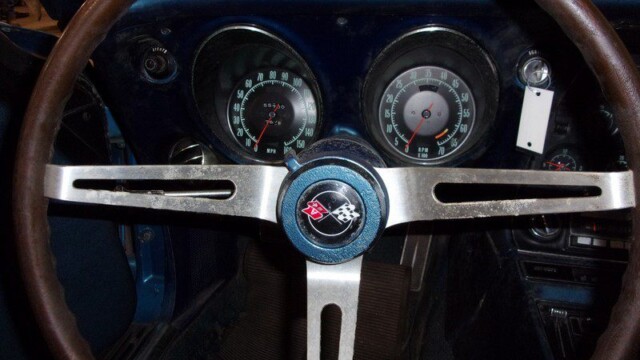 Classic Corvette's interior dashboard and steering wheel.