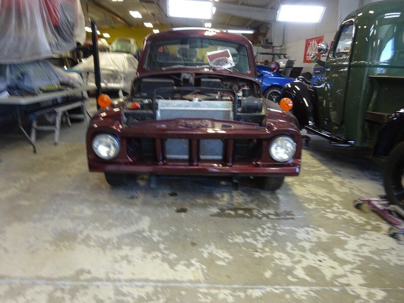 Maroon vintage truck in garage.