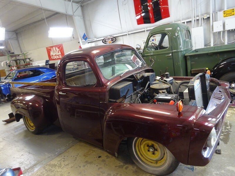 Maroon vintage truck under restoration.