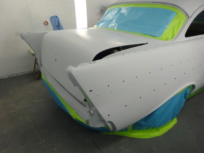 Primered vintage car body in progress.