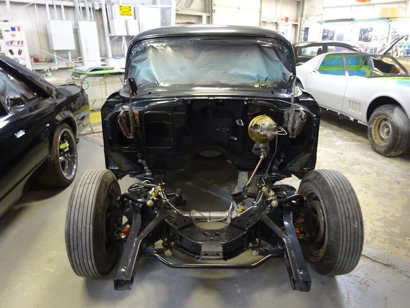 Black classic car chassis restoration.