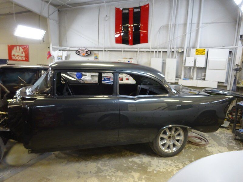 Dark gray classic car body in shop.