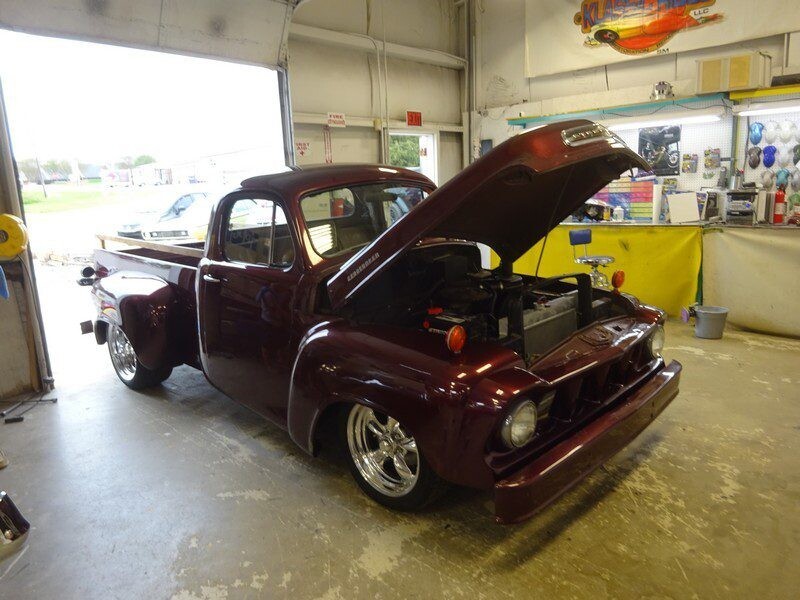Maroon classic truck, hood up.