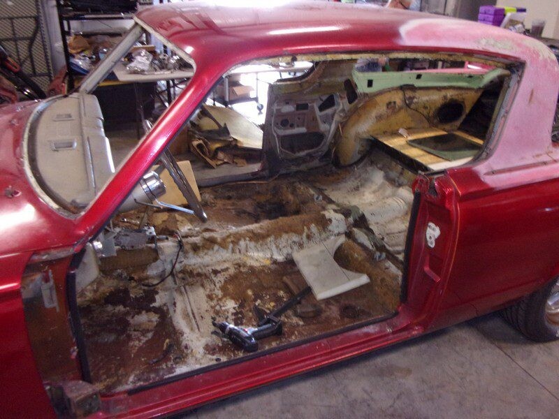 Red car's interior under restoration.