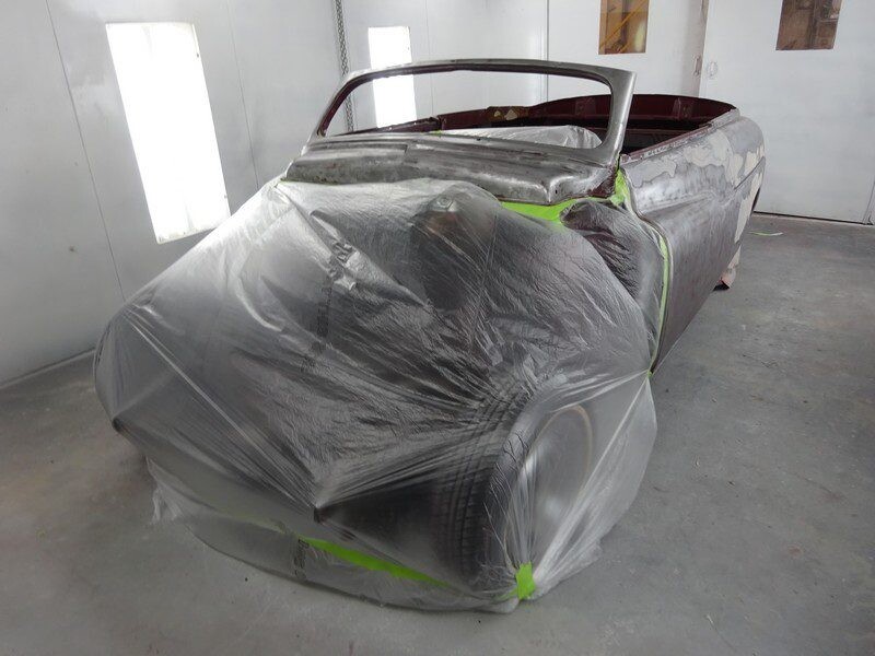 Classic car covered in plastic wrap.