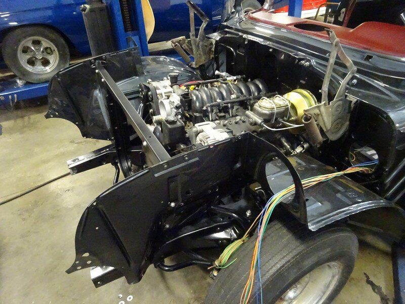 Car engine bay under construction.