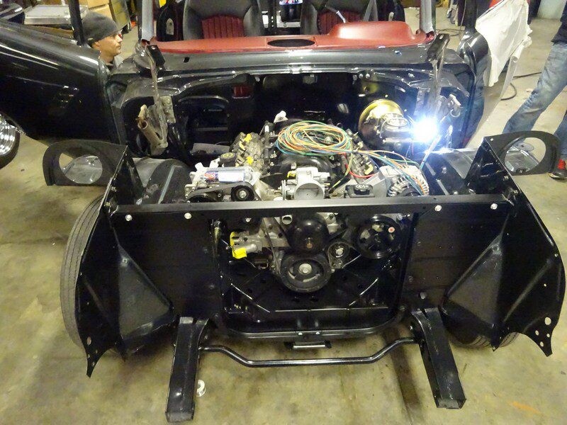 Car engine bay under construction.