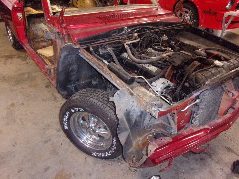 Red classic car engine bay restoration.