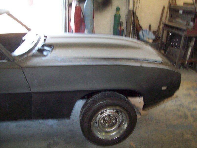 Primered classic car undergoing restoration.