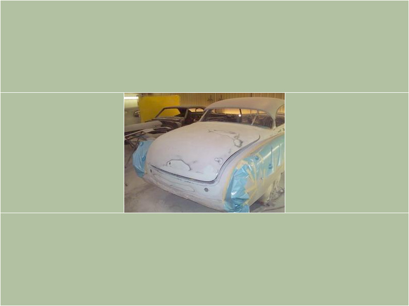 Here's an alt tag for the image: `Classic car undergoing bodywork restoration`