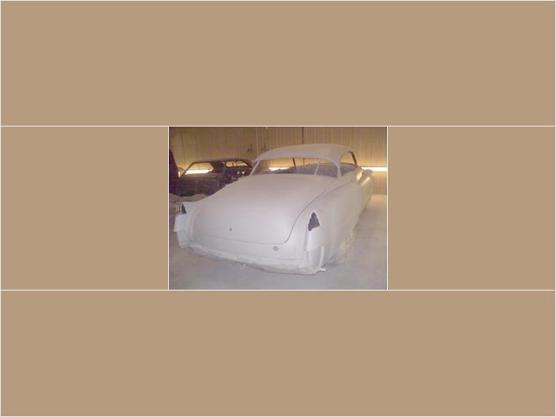 Here's an alt tag for the image: `Classic car in primer, rear view`