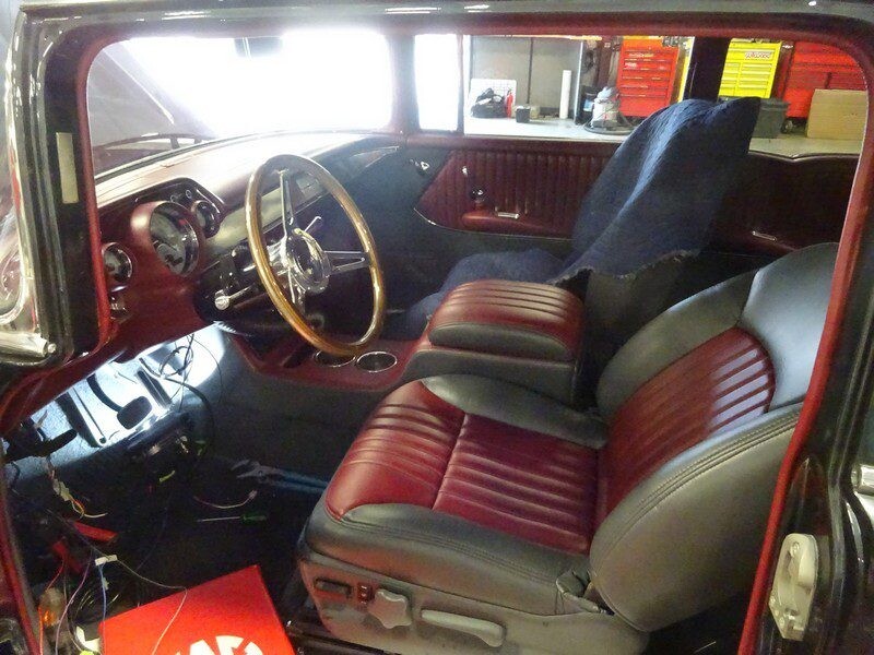 Here's an 8-word alt tag for the image: Custom red and gray vintage car interior.