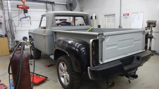 Classic truck undergoing restoration in garage.